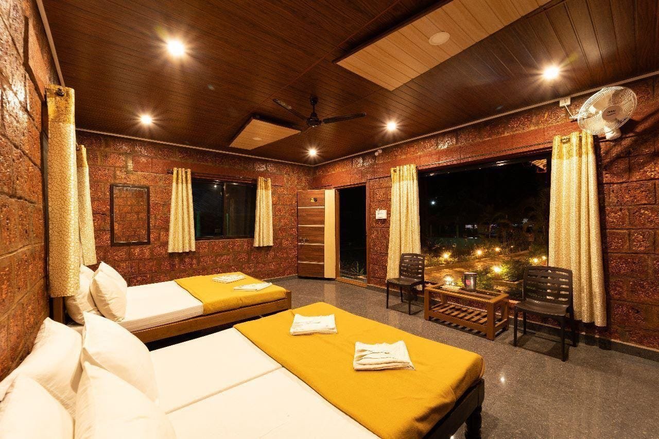 Laterite-walled room with sit-out chairs